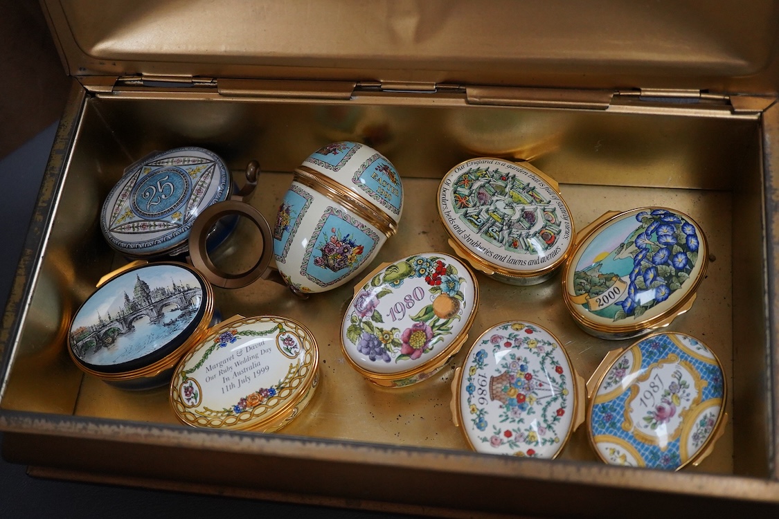 Eighteen Halcyon days enamel boxes and an enamel egg shaped box on stand
